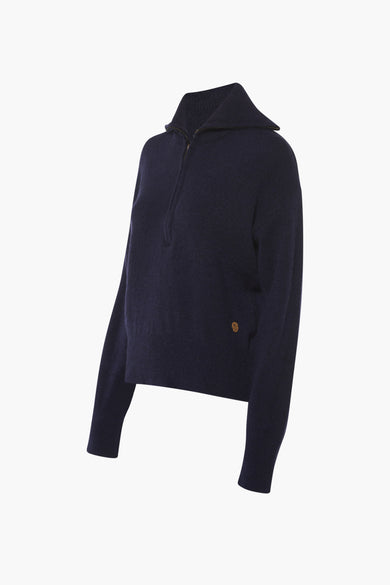 T-shirt bleu avec fermeture à glissière courte de Le Fabuleux Marcel de Bruxelles, avec col montant et détail doré.
