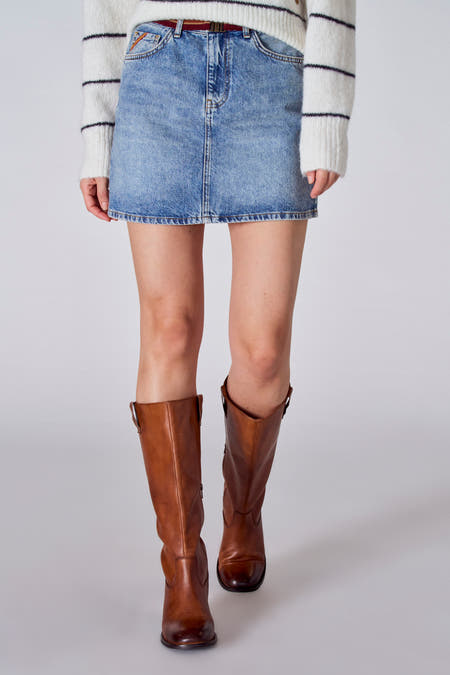 Short light blue denim skirt from Le Fabuleux Marcel de Bruxelles, with a white striped shirt and brown boots.