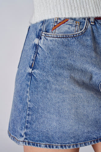 Short light blue denim skirt from Le Fabuleux Marcel de Bruxelles, with a decorative stripe at the pocket.