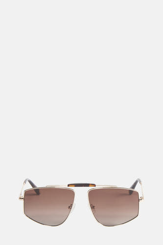 Lunettes de soleil dorées de Le Fabuleux Marcel de Bruxelles, avec une lentille brune en dégradé et un motif tortue au-dessus du pont nasal.