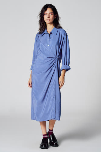 Tunique bleue à longues manches de Le Fabuleux Marcel de Bruxelles, avec un motif rayé et un détail de nœud sur le côté.