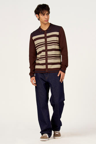 Gilet marron de Le Fabuleux Marcel de Bruxelles, avec des rayures horizontales et une fermeture boutonnée, combiné avec un jean foncé et des baskets marron.