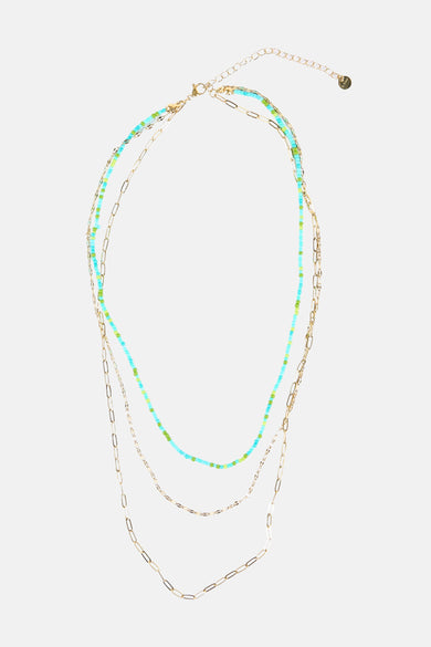 Collier court multicolore de Le Fabuleux Marcel de Bruxelles, avec des perles bleues et vertes et des chaînes dorées.