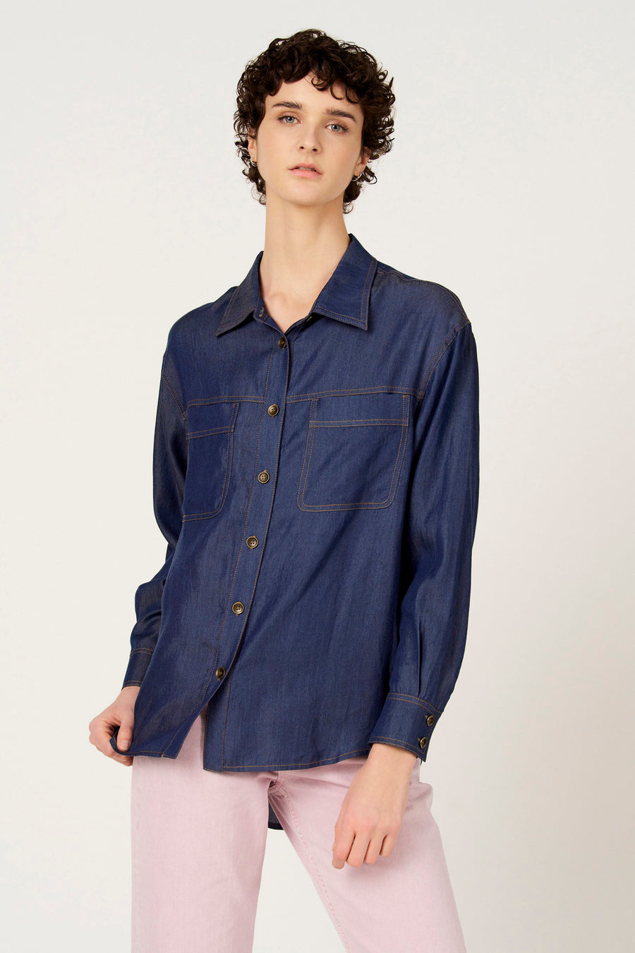 Chemise en jean bleu foncé à manches longues de Le Fabuleux Marcel de Bruxelles, avec poches poitrine et surpiqûres colorées.