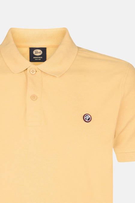 Polo jaune à manches courtes de Petrol Industries, avec col boutonné et un petit logo.