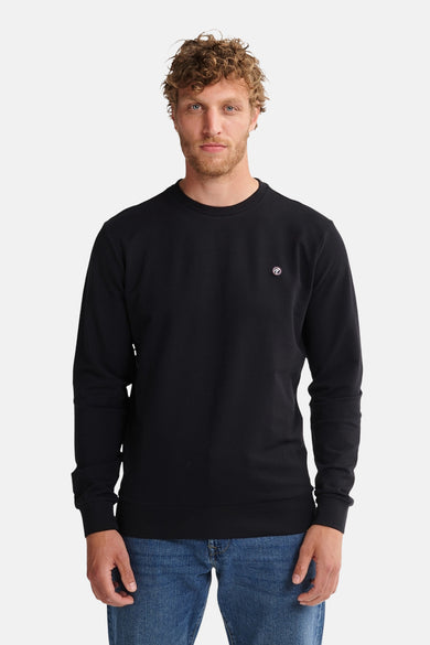 Gilet noir de Petrol Industries® avec des manches longues et un petit logo sur la poitrine.