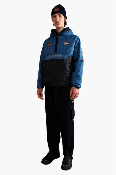 Pantalon cargo noir NAPAPIJRI, avec poches, porté avec un blazer bleu et noir et un bonnet.