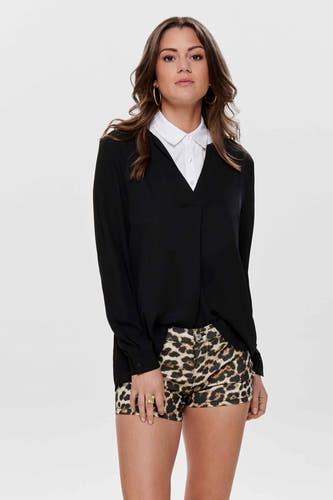 Collier blanc de ONLY®, porté sous une blouse noire et associé à des shorts imprimés léopard.