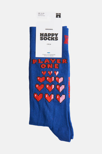 Chaussettes bleues de Happy Socks, avec des cœurs pixels rouges et roses et le texte "Player One".