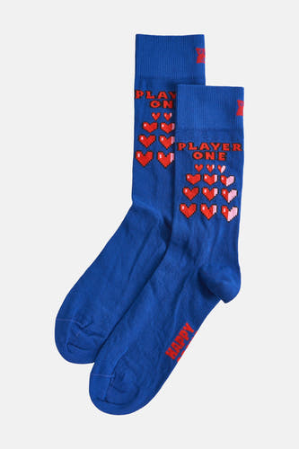Chaussettes bleues de Happy Socks, avec des cœurs pixels rouges et l'inscription "Player One" et "Play On".