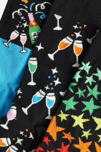 Gants de cadeau Happy Socks® avec des avecons de champagne colorés et des motifs d'étoiles.