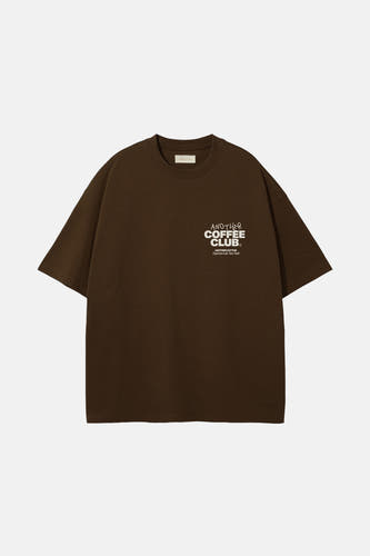 T-shirt brun à manches courtes d'ANOTHER COTTON LAB, avec une impression de texte blanche sur la poitrine.
