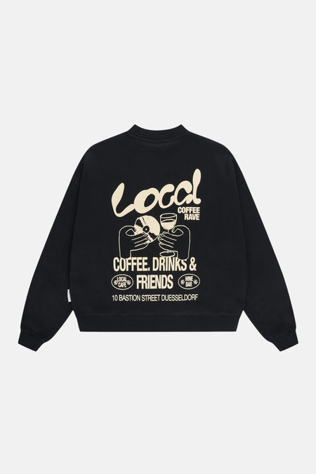 Zwarte sweater van ANOTHER COTTON LAB met witte grafische opdruk van "Local Coffee Rave" op de rug.