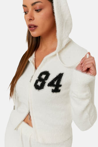 Cardigan blanc de TALLY WEIJL avec le numéro "84" sur l'avant, avec capuche et fermeture éclair.