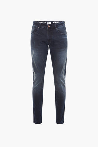 Jean slim fit bleu marine de Petrol Industries, avec des détails de usure subtils.