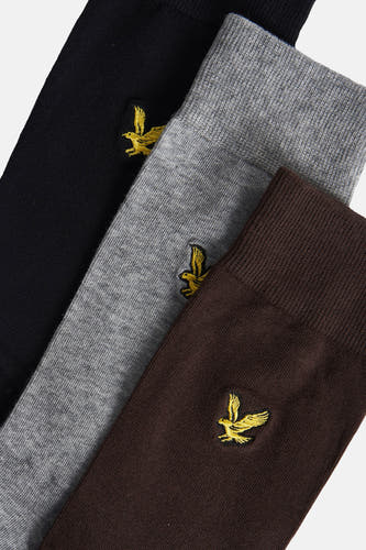 Chaussettes multicolores de LYLE & SCOTT avec un aigle doré brodé sur une chaussette noire, grise et marron.