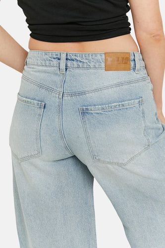 Blauwe jeans achterkant met leren label.