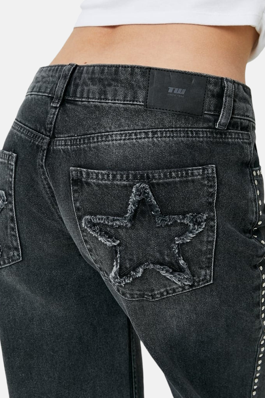 Jean droit gris moyen de TALLY WEIJL, avec étoile usée sur la poche arrière, clous le long de la couture latérale et étiquette noire sur la ceinture.