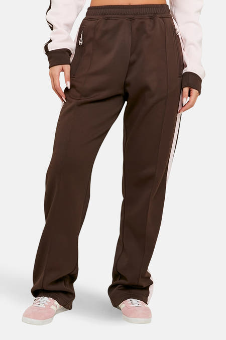 Bruine joggingbroek van TALLY WEIJL, met een witte streep aan de zijkant en zakken met rits.