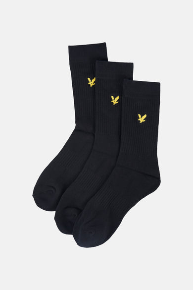 Chaussettes noires Lyle & Scott avec un logo jaune brodé sur la tige.