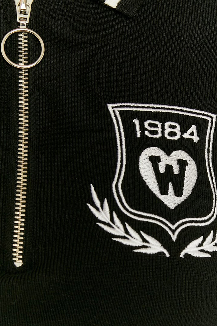 Gilet noir à col V de TALLY WEIJL, avec fermeture éclair et logo brodé.