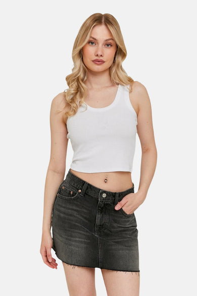Short dark gray denim skirt from TALLY WEIJL, with a ruffled hem and worn by a woman.