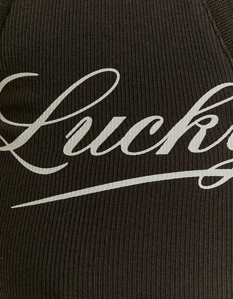 Veste noire de TALLY WEIJL avec lettrage "Lucky" blanc et texture rayée.