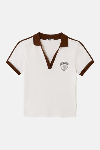 Polo blanche à manches courtes de TALLY WEIJL, avec des détails marron sur le col et les manches, et un écusson sur la poitrine.