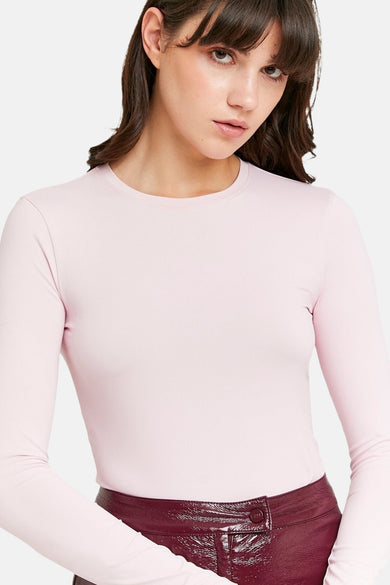 T-shirt rose à manches longues de TALLY WEIJL, associé à un pantalon brillant en bordeaux.