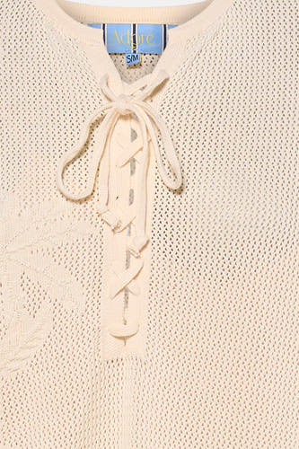 Ecru gebreid mouwloos kleedje van Adore met strikdetail en open voorkant, close-up voorzijde