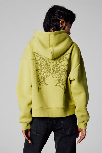Pull-over vert de Unwind avec capuche, imprimé d'ailes sur le dos.