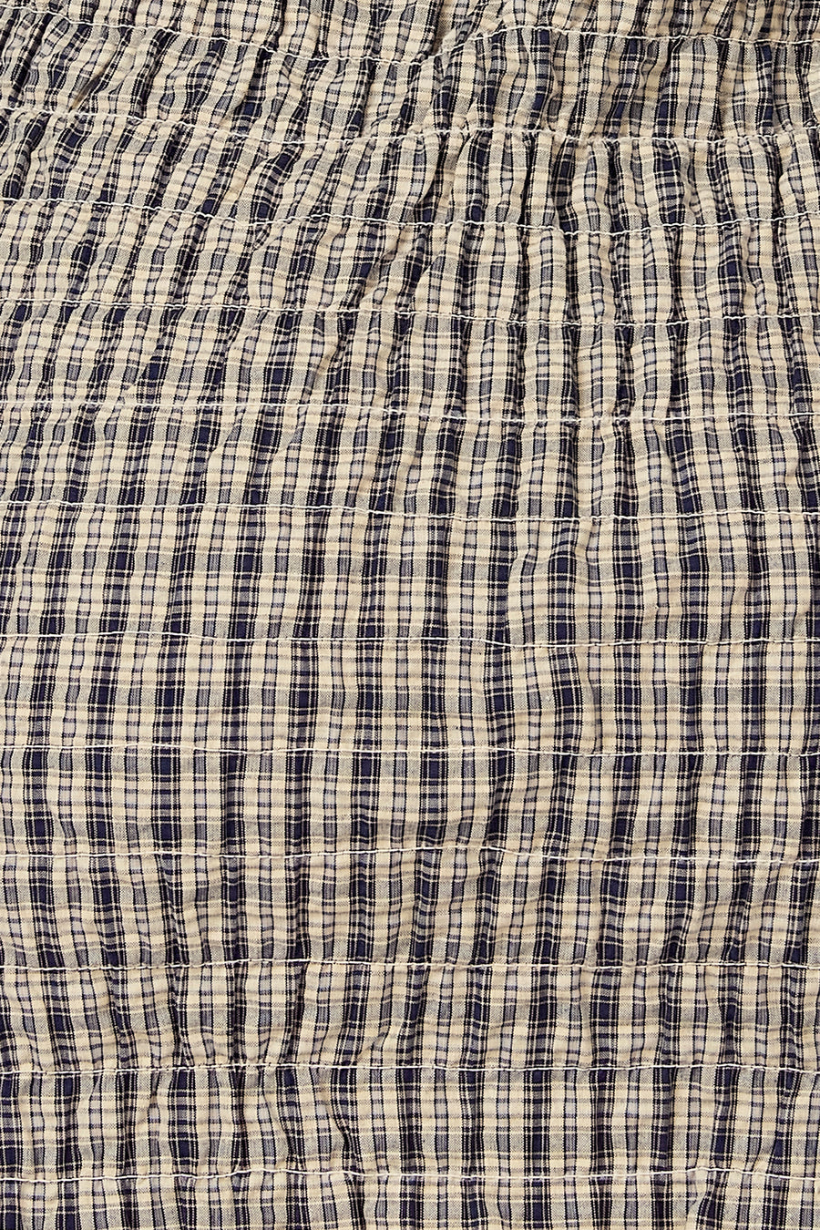 Robe bleue sans manches d'Unwind, avec un imprimé à carreaux et des détails élastiques.