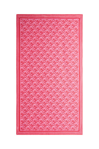 Maillot de plage en tissu éponge rose de TOMMY JEANS avec un motif répétitif de lettres 'Joy' rouges et une texture douce.