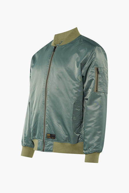 Veste courte verte VANS 'OFF THE WALL' en nylon brillant avec poignets côtelés vert olive et poche sur la manche.