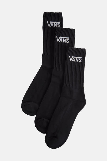 Chaussettes noires de VANS, avec logo blanc imprimé et texture rayée, en gros plan.