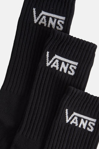 Zwarte sokken van VANS, met witte logo-opdruk en geribbelde textuur, in close-up.
