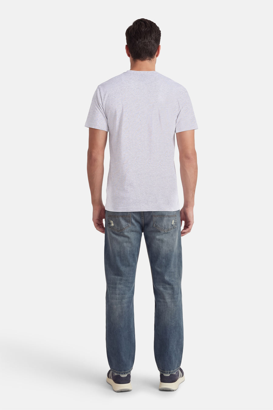 T-shirt gris à manches courtes VANS "OFF THE WALL", vu de dos, combiné avec un jean bleu et des baskets.