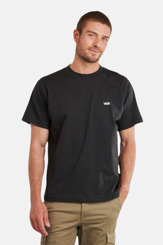 T-shirt noir à manches courtes de VANS "OFF THE WALL", vu de dos avec un pantalon kaki et des chaussures noires.
