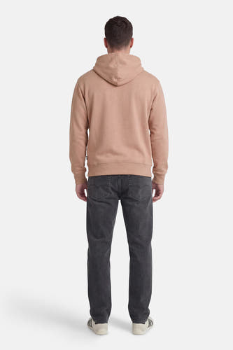 Pull beige à capuche VANS "OFF THE WALL", vu de dos, porté avec un jean gris foncé et des baskets.