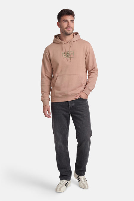 Pull beige à capuche VANS "OFF THE WALL", à manches longues et poche kangourou, combiné avec un jean noir et des baskets.