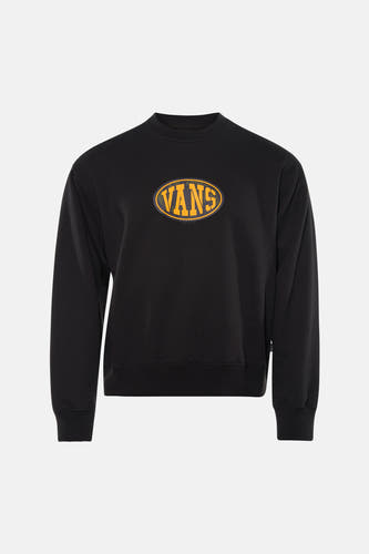 Pull noir VANS "OFF THE WALL" avec logo jaune sur la poitrine, associé à un jean bleu et des baskets blanches.