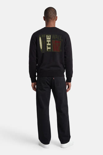 Zwarte sweater met ronde hals van VANS “OFF THE WALL” met opvallende grafische print op de rug.