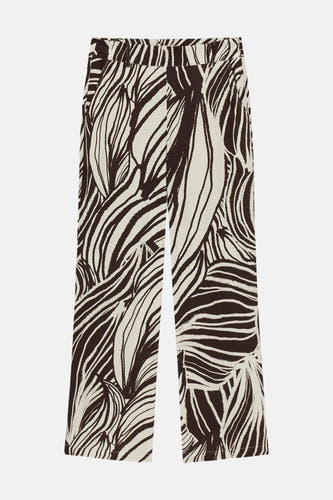 Pantalon crème à motif de feuilles abstrait de Guess®, à jambes larges, posé à plat.