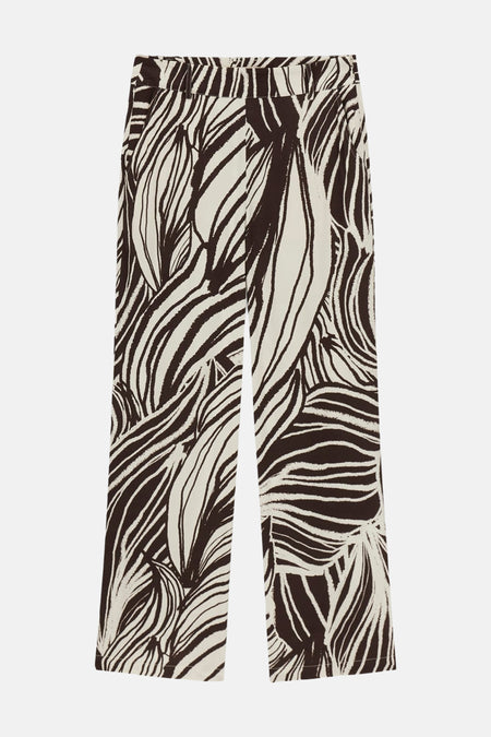 Pantalon crème à motif de feuilles abstrait de Guess®, à jambes larges, posé à plat.