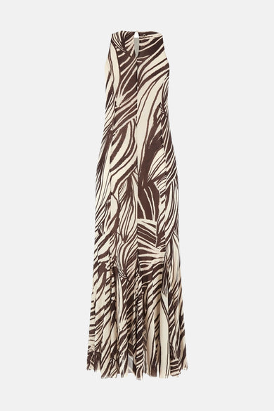 Een lang mouwloos kleedje in bruin en crème van Guess, met abstract streepdessin en halterhals met sleutelgat.