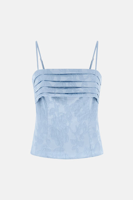 Blouse sans manches bleue de Guess®, avec une subtile impression de fleurs et un zip à l'avant.