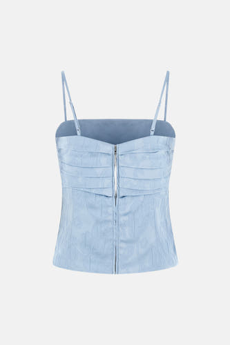 Blauwe mouwloze blouse van Guess®, met een subtiele bloemenprint en een ritssluiting aan de voorkant.
