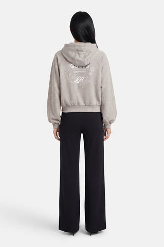 Gilet gris de Guess, à manches longues, avec capuche et étoiles et lettres décoratives de couleur argentée au dos.