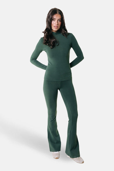 Groene joggingbroek van COLOURFUL REBEL, gecombineerd met een bijpassende groene top en witte sneakers.