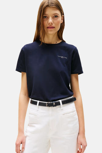 T-shirt bleu à manches courtes de TOMMY HILFIGER, porté avec un pantalon blanc et des chaussures loafers.